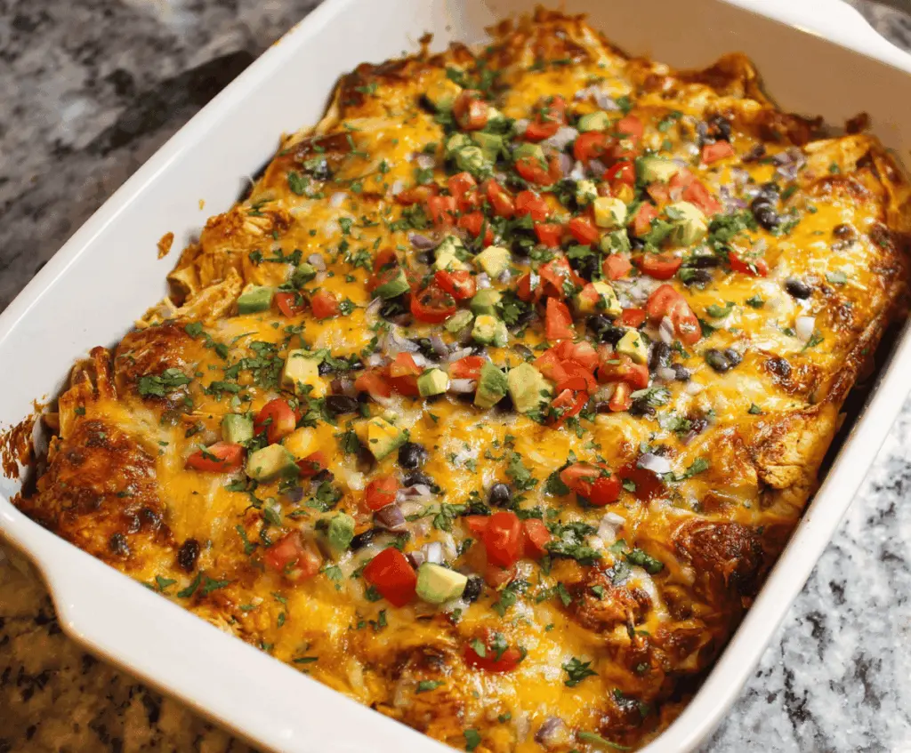 Delicious Chicken Enchilada Casserole topped with melted cheese, fresh cilantro, and sliced jalapenos on a serving dish