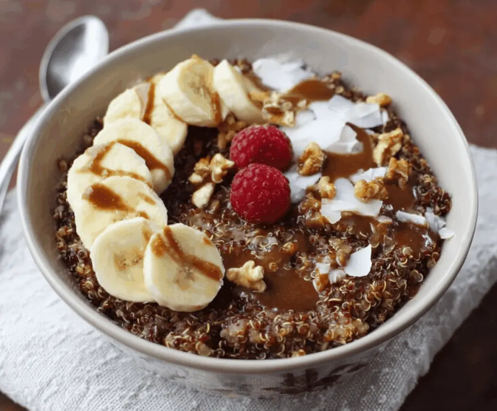 Creamy Chunky Monkey Quinoa Breakfast Bowl topped with banana slices, walnuts, and chocolate chips for a nutritious morning meal