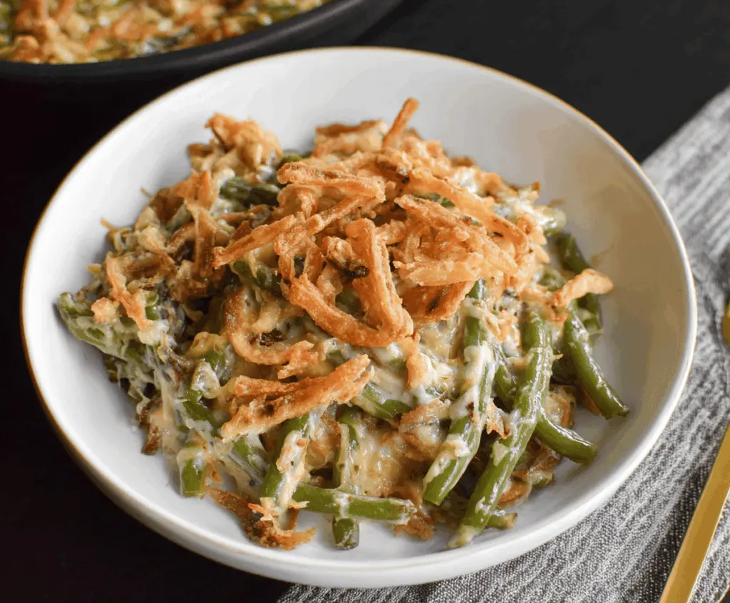 Delicious homemade slow cooker green bean casserole topped with crispy fried onions, ready to serve as a savory holiday side dish